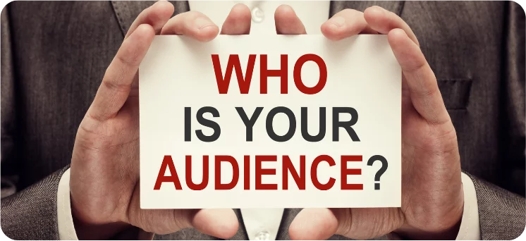 Hands holding a board with “Who is Your Audience?” written on it